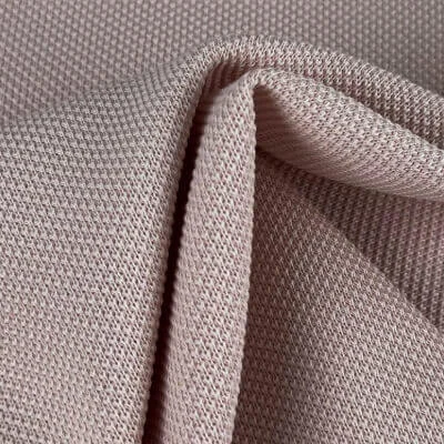 Piqué fabric with textured knit commonly used in polo apparel manufacturing by Hesson Apparel