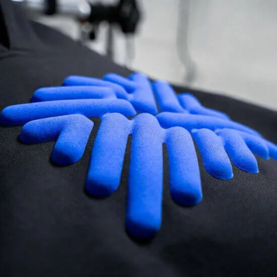 Puff printing technique creating raised texture and bold logo details on apparel by Hesson Apparel