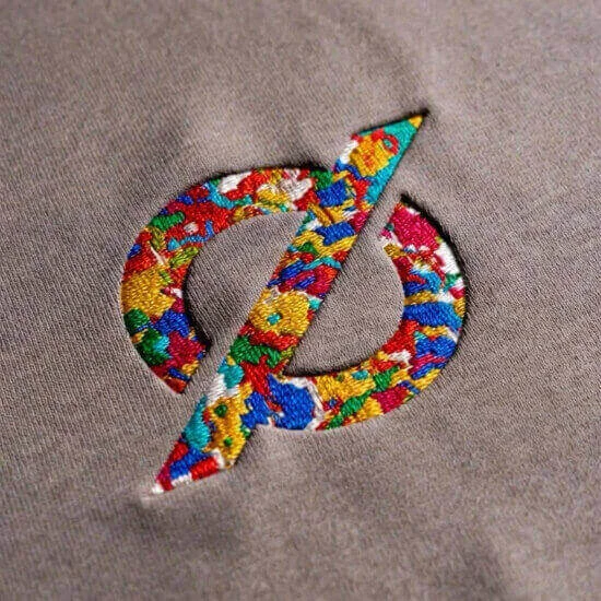 Flat embroidery technique for clean, precise logo stitching on apparel by Hesson Apparel